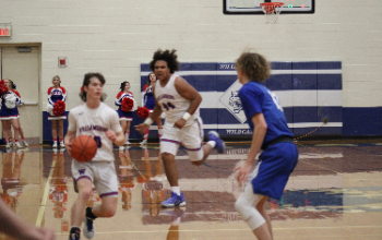 Boys dribbling basketball