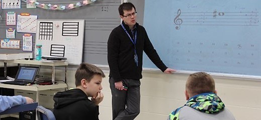 Teacher teaching his students in class