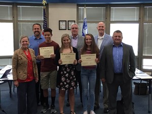 Students being awarded by the board members