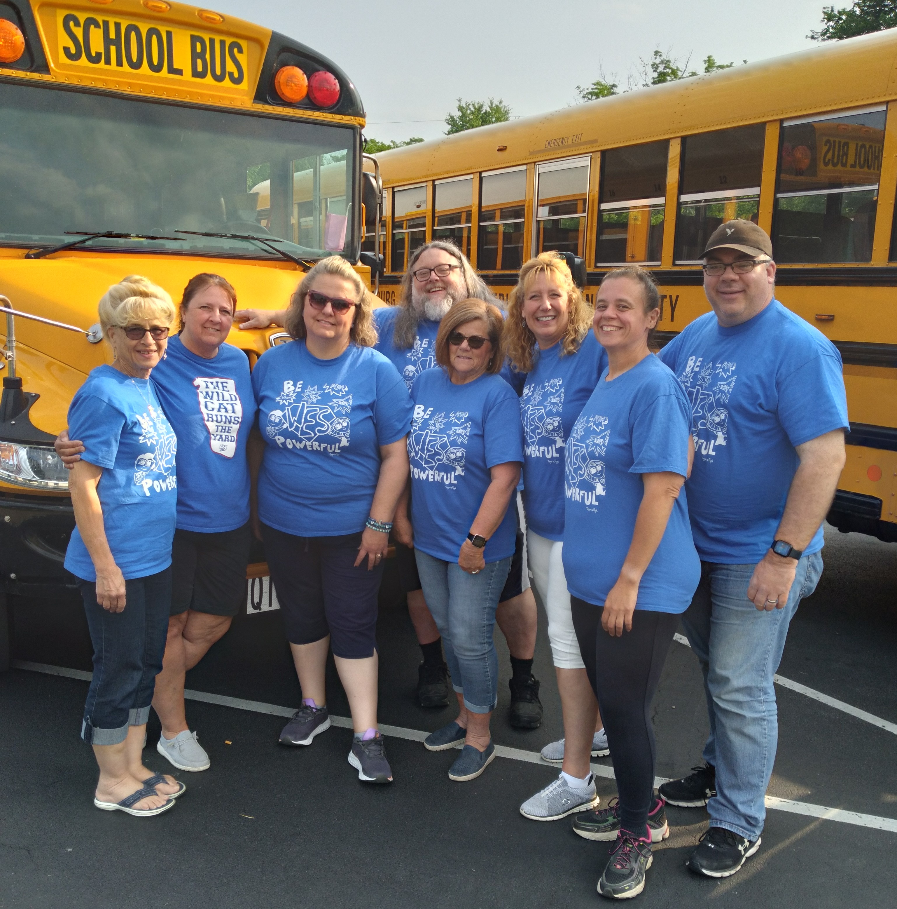 District bus drivers pictured in front of a school bus